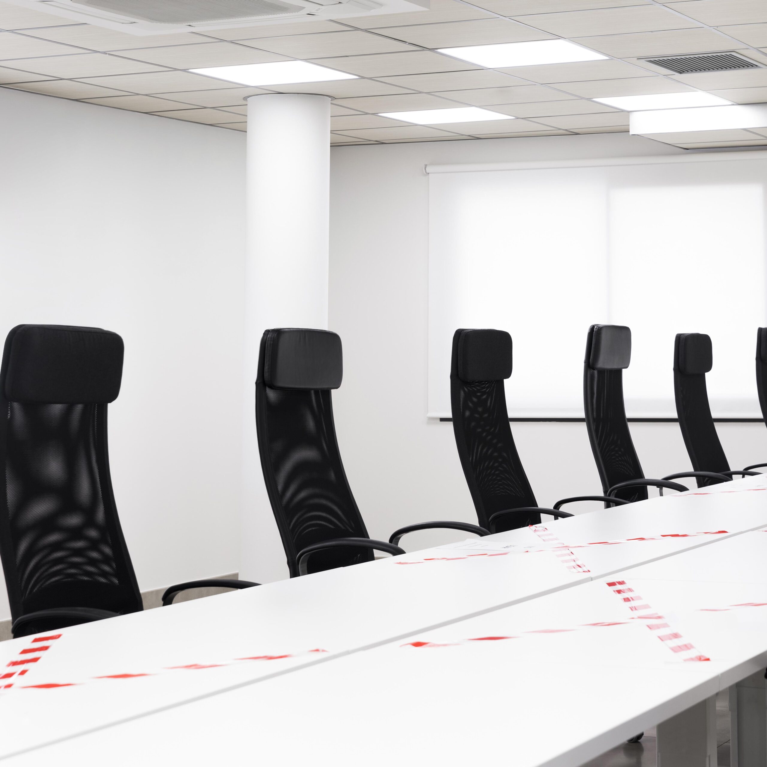 empty conference room with black chairs scaled